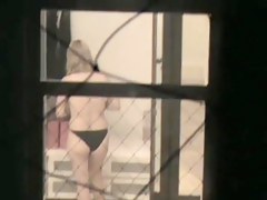 Girl strips and touches nude tits on window voyeur movie