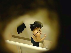 This cute babe is spotted in a changing room with naked boobs