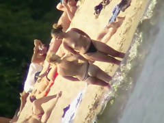 Mature women with big butts taking sunbaths on the beach