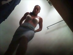 Seductive fem puts on her office suit in the changing room