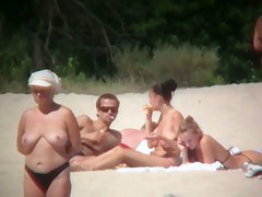 Huge boobed sexy ladies lie on the beach and relaxing