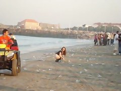 A fresh boozed girl pissing in public on the beach